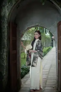 Graceful Vietnamese Woman in Ao Dai Amidst Ancient Architecture - image 0
