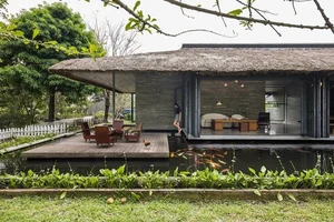 Architectural Marvel: Exploring the Stunning Thatched-Roof Villa Surrounded by Water in Long An - image 0