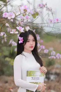 Elegant Vietnamese Student in Ao Dai Amidst Bauhinia Flowers - image 5