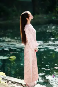 Vietnamese Charm: Elegant Beauty in Pink Traditional Attire - image 11