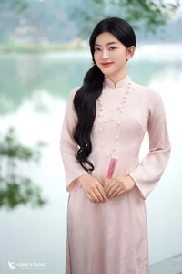 Graceful Muse in Traditional Pink Ao Dai - image 1